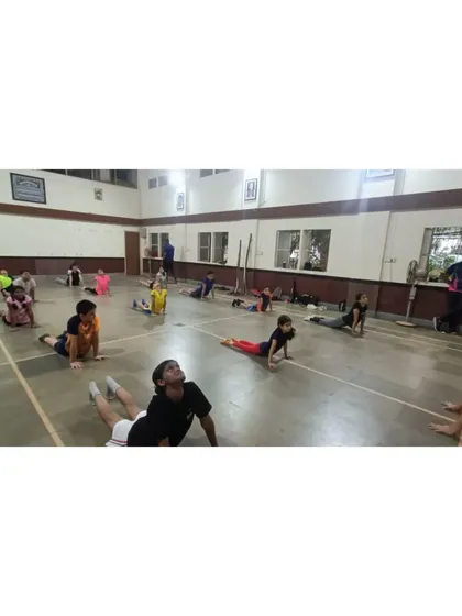 Another shot from our yoga session, with students practicing a back-bending asana. These activities help build a holistic approach to fitness.