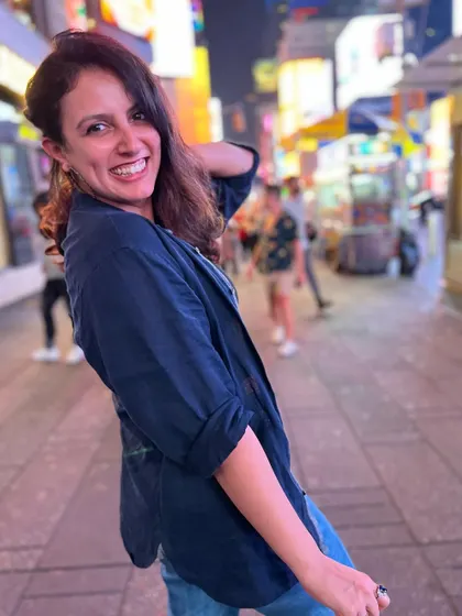 The lights of Times Square make for the best background. A happy, candid shot that captures the vibrant energy of NYC at night.