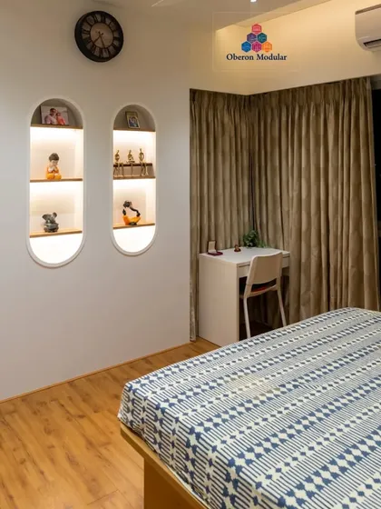 We create unique design elements like these backlit, arched wall niches. They provide a beautiful display area for personal treasures and add a soft, ambient glow to the bedroom.
