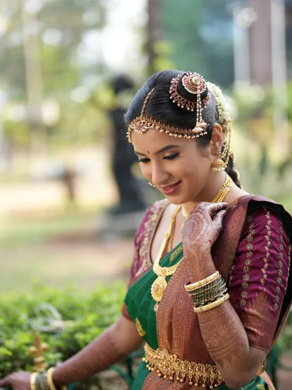 A side view showing the elegant hair accessory and the flawless finish of the makeup on her skin.