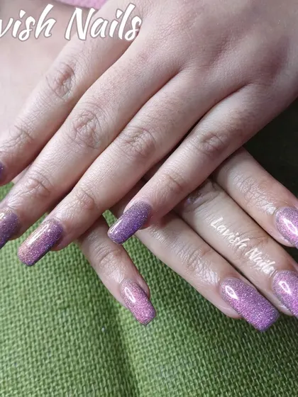 Long square nails with a beautiful purple holographic glitter finish.