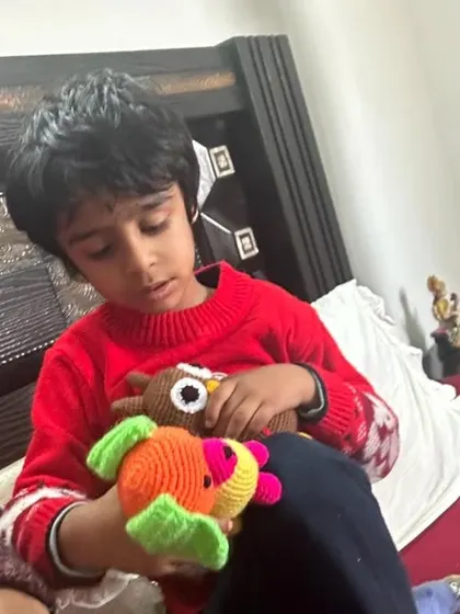 The little boy looking closely at his new handmade toys.