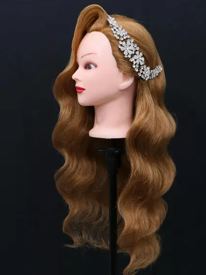 Classic Hollywood waves on a mannequin, demonstrating the perfect S-curve pattern that students learn to master.