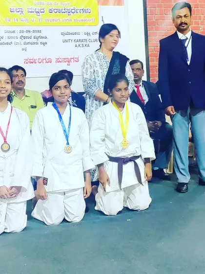 My female students proudly display their medals. Their dedication in training shows in their results.