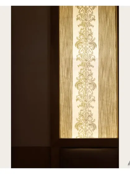 A close-up of the illuminated fabric panel on the headboard. This detail showcases our use of light and texture to create focal points and add a sense of luxury to the bedroom.