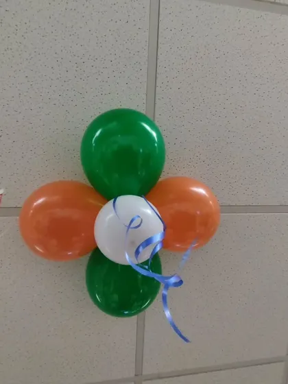 A close-up of a simple four-balloon cluster in the Indian flag colors. These small details, when placed strategically on ceilings or walls, contribute to a complete and professional look.
