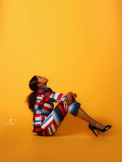 A contemplative pose on the floor, looking up. The use of negative space is powerful, creating a feeling of hope or aspiration.