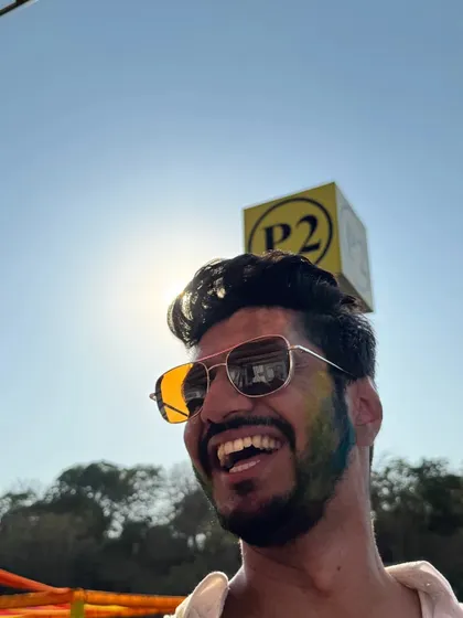 Golden hour plus Holi colors equals a masterpiece. A candid shot capturing the pure happiness and vibrant atmosphere of a Holi music festival.