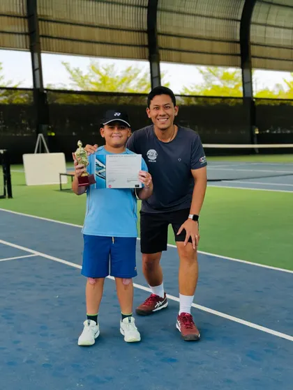 A proud moment for one of our youngest winners, posing with his coach and trophy. We believe in celebrating every achievement on the journey to excellence.