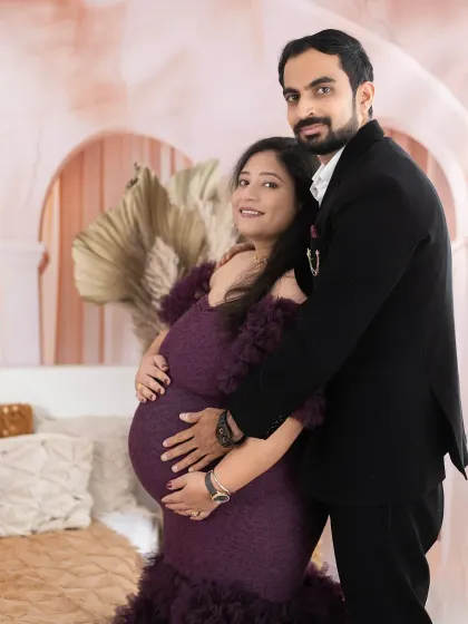 An intimate portrait of an expecting couple, capturing the feeling of "the bonds that tie you together." This photo was taken in our boho setup, featuring a beautiful wine-colored gown.