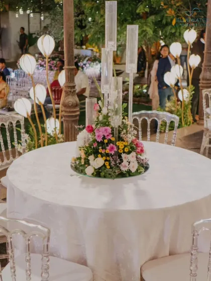 A guest table at the reception, featuring a beautiful floral centerpiece.