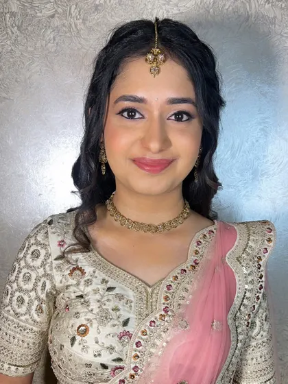 A soft and pretty look for a reception or engagement. The makeup is minimal and fresh, with a focus on clean skin and natural-looking eye makeup.