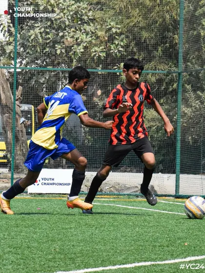 A young player on the dribble, taking on a defender during a Youth Championship match. We encourage our players to be confident on the ball.