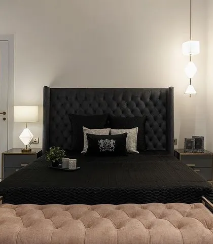 A teenage boy's retreat, featuring our custom bed with a dramatic, tall, button-tufted headboard in black, paired with a contrasting pink tufted bench.