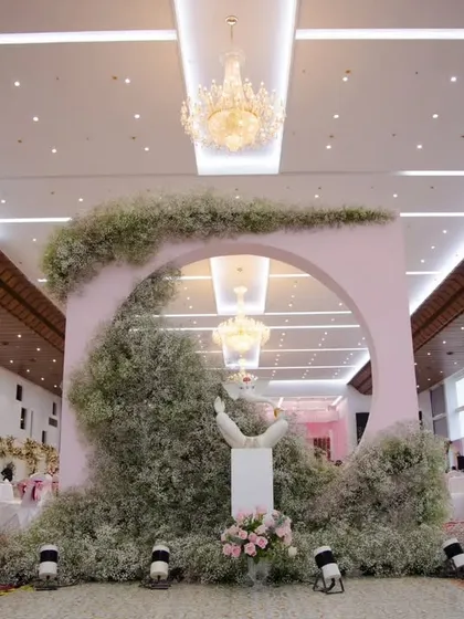 This unique photo booth was a highlight of the reception. A circular arch enveloped in delicate baby's breath provides a dreamy, cloud-like effect for beautiful guest portraits.