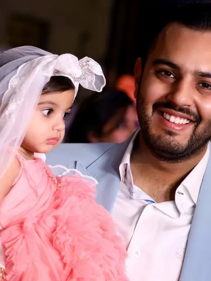 A close-up shot capturing the loving gaze of a father towards his daughter. These intimate portraits are precious keepsakes from any family function.