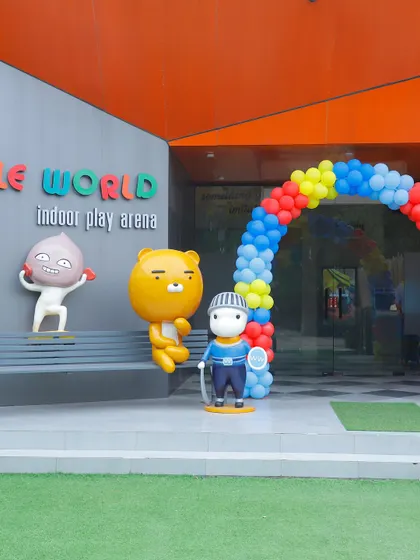 The entrance to Wobble World decorated with a classic red, yellow, and blue balloon arch for a birthday party.