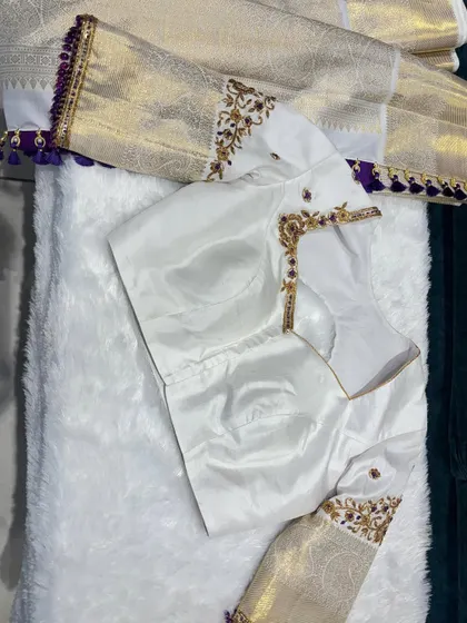 A dreamy combination of a white blouse with a purple border and delicate gold embroidery.