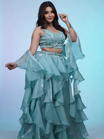 The drama of this ruffled blue lehenga is unmatched. The tiered skirt and bell sleeves create a stunning silhouette that's made for dancing the night away.