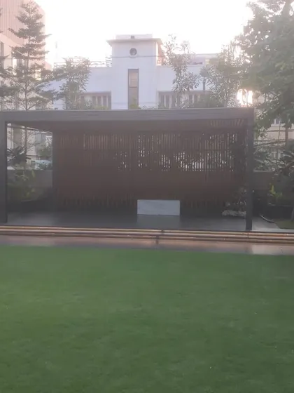 This large pergola and screen structure creates a private and shaded seating area within a larger garden. It's a great way to create distinct zones in your outdoor space.