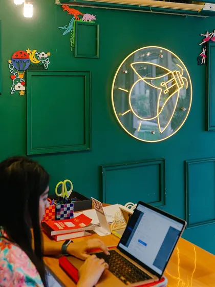 Our signature Firefly neon sign lighting up the creative space. I wanted to create a welcoming and inspiring environment where you feel comfortable letting your imagination run wild.