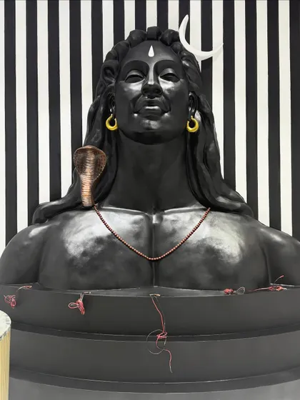 A straight-on view of the Adiyogi sculpture before the base was fully concealed. You can see the detail in the rudraksha mala and the cobra, all sculpted and painted by hand.