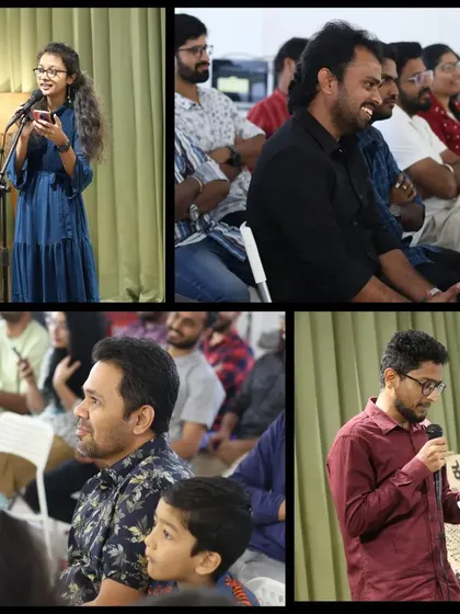 A young performer shares her poetry while the audience listens intently.