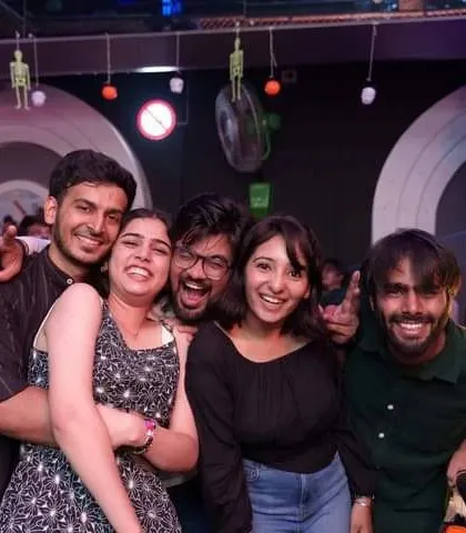 A group of friends laughing and hugging. These are the moments of pure fun and friendship that my music helps create.