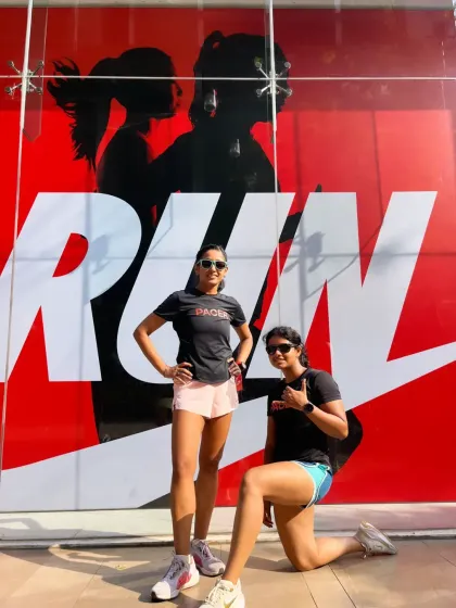 Posing with a fellow pacer in front of a Nike Run mural. We are here to support and guide you through every step of your run.