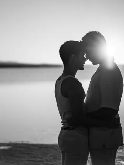 A powerful and intimate silhouette of two souls connecting as the sun sets over the water in Turkey. This image represents our core belief that all love is beautiful and deserves to be celebrated with artistry and grace.