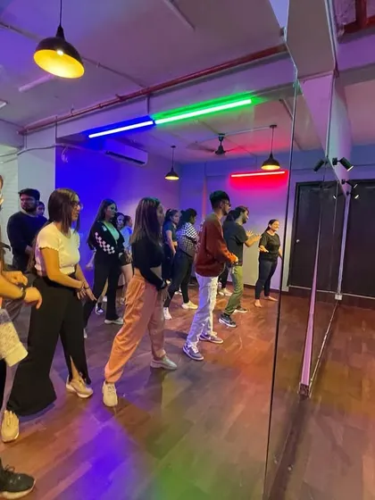 The full-length mirrors are a key asset during workshops, allowing a large group of dancers to learn and practice in unison while following the instructor.