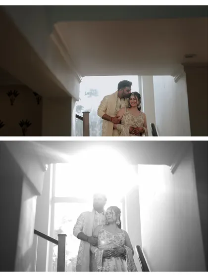 A creative play of light and shadow, capturing the couple in a tender embrace on a staircase during their engagement shoot.
