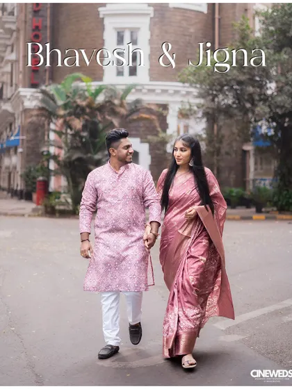 A classic pre-wedding shot of a couple walking hand-in-hand through the streets of Colaba, with the iconic Taj Mahal Palace Hotel in the background.