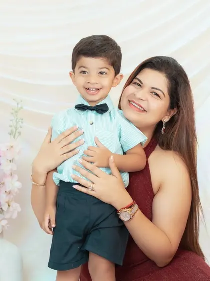 A mother holds her son, both sharing a beautiful smile. These are the simple, happy moments we love to freeze in time.
