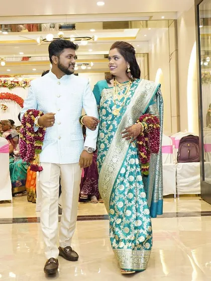 The couple walking into their reception hall, looking perfectly coordinated and in love.
