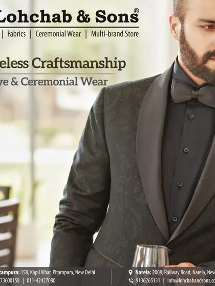 Priceless craftsmanship is evident in every detail. This close-up highlights the subtle texture of the fabric and the smooth curve of the shawl lapel on this all-black tuxedo, perfect for a sophisticated evening look.