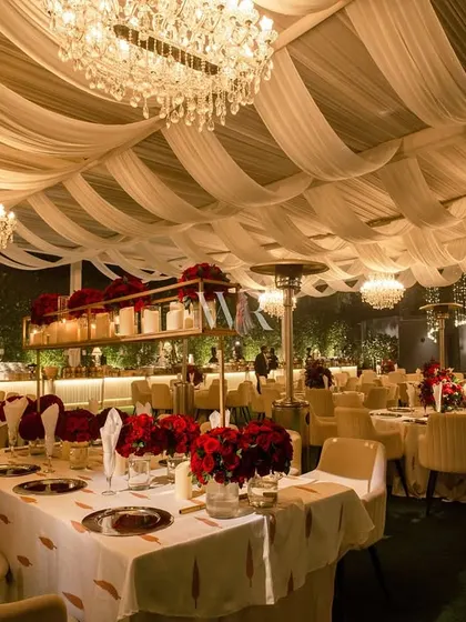 Another angle of the grand dining hall. The repetition of the chandeliers and the elegant table settings creates a powerful sense of rhythm and luxury.