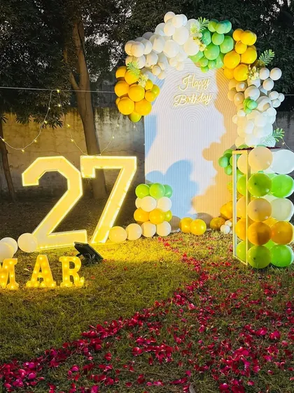 A wide shot of the 27th birthday outdoor decoration, capturing the beautiful ambiance created by the lights at night.