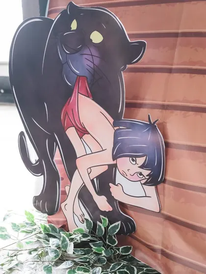 A large cutout of Bagheera and Mowgli adds a dramatic and story-driven element to the Jungle Book themed celebration.
