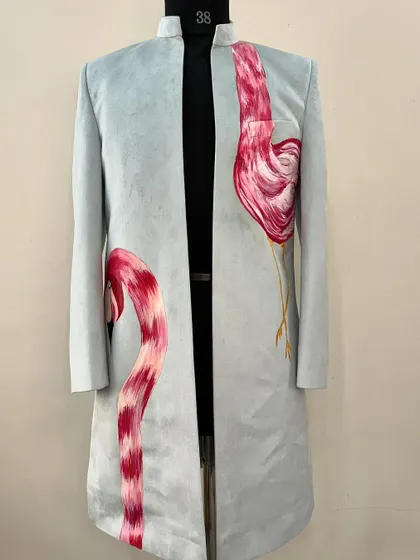 Be a flamingo in a flock of pigeons. I painted these elegant flamingos on a light blue sherwani, using their graceful curves to create a unique and eye-catching design.