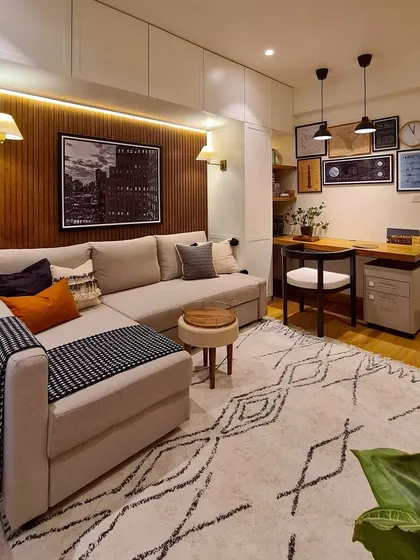 Today's homes need to be flexible. I designed this media room to be a true multi-functional space. It serves as a cozy home theater, a guest room with a sofa that converts to a bed, and a practical home office with a built-in desk, all surrounded by seamless, hidden storage.