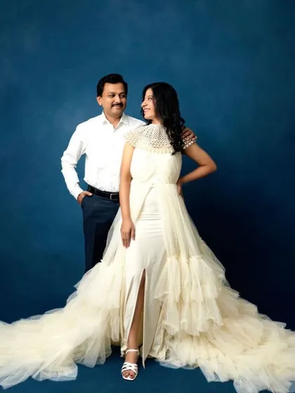 A moment of quiet connection between partners. This elegant studio portrait showcases a couple in a stylish pose, celebrating their bond with a touch of glamour.