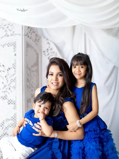A mother with her two children, all dressed in blue. This portrait beautifully captures the love and happiness of this sweet family.