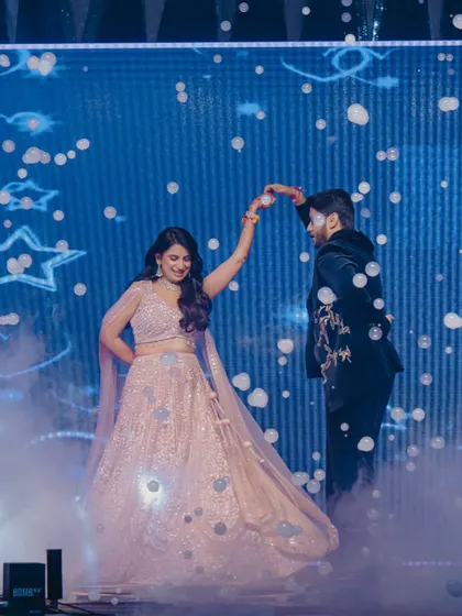 A fairytale first dance. I used a bubble machine and a dreamy blue LED backdrop with star motifs to create this magical moment, making the couple feel like they were dancing in the clouds.