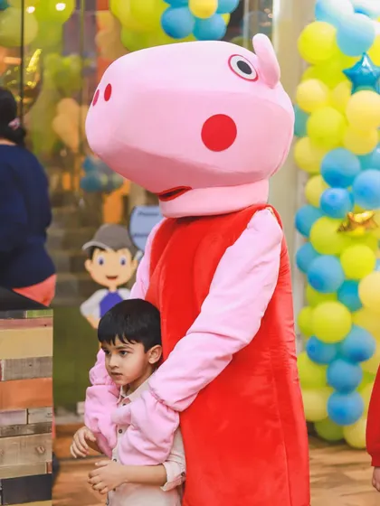 A gentle hug from Peppa Pig for one of the little guests. These special interactions are what make a Funtopia party so memorable.
