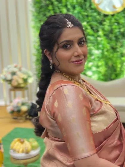 A smiling portrait of the mom-to-be. The saree drape is neat and allows her to move around and enjoy her baby shower ceremony with ease.