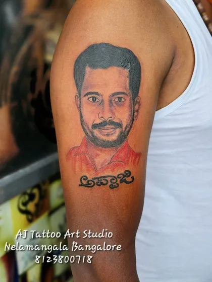 This is the kind of work I love to do. A realistic portrait tattoo to honor 'Appaji' (father), capturing his likeness on the upper arm. Creating these memorial tattoos is a privilege.