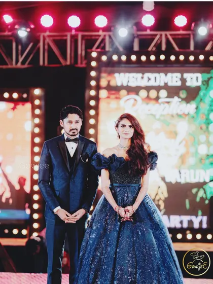 The couple looking regal on their reception stage, ready to welcome their guests.
