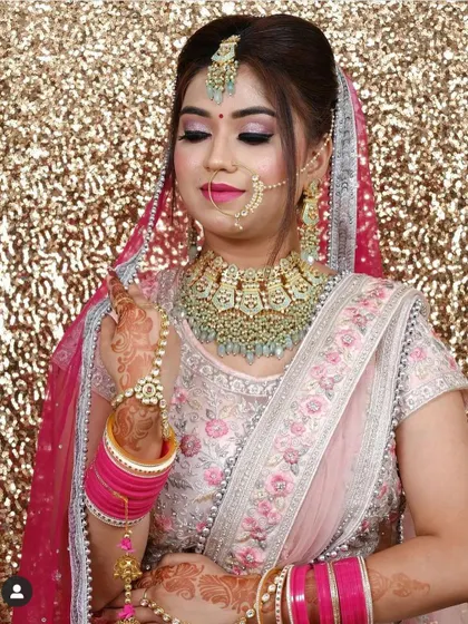 Another view of the mint green Kundan set against a pastel pink outfit, showing the full effect of this trendy and elegant bridal look.