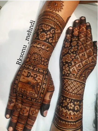 The full view of the semi-bridal design featuring the romantic beach scene. The personalized panel is balanced with traditional floral and geometric patterns on the rest of the hands and arms.